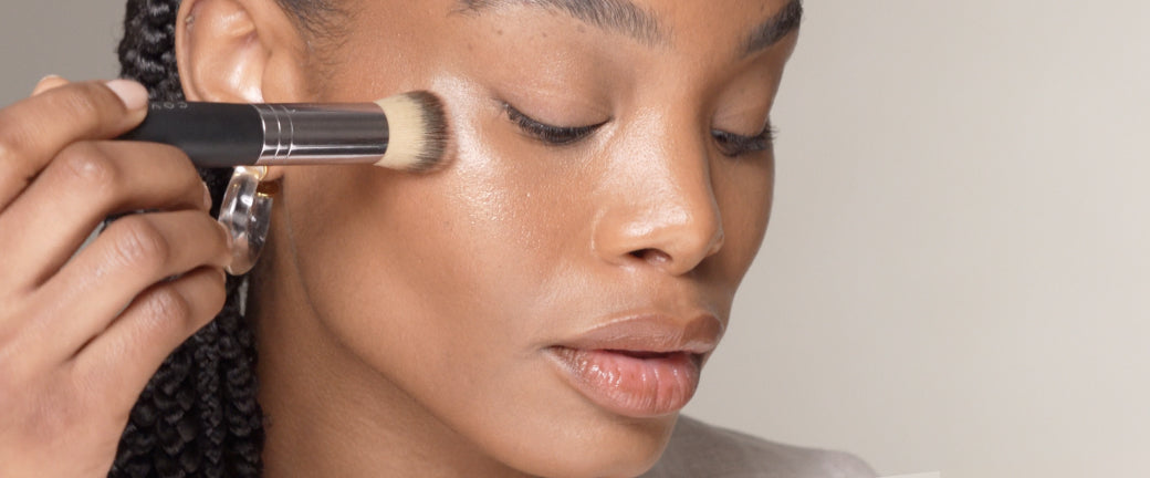 Photo of woman using the stippling method to apply foundation